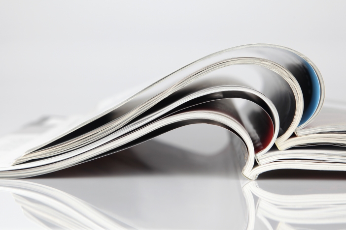 Open textbook with a pen resting on the page